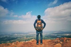 man in backpack thinking about addiction recovery programs