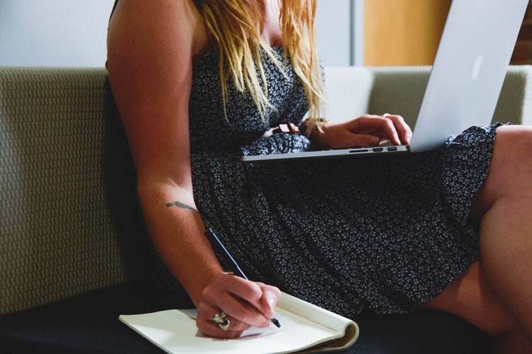 Woman Writing Down Benefits of Living in a Sober Home
