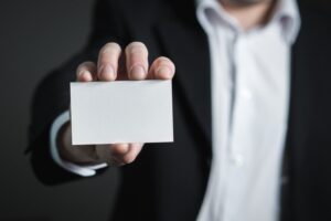 Man holding blank card, not identifying with his addiction.
