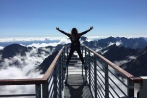 Sober girl on top of the mountains in nature