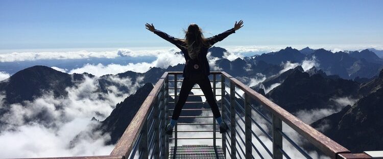 Sober girl on top of the mountains in nature