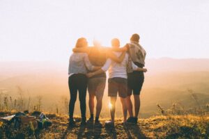 Group of friends looking out into the sun outside of a sober living home