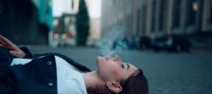 Woman laying down smoking in Massachusetts