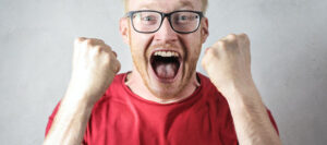 Man screaming in anger after being triggered