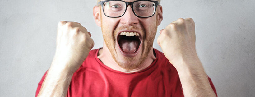 Man screaming in anger after being triggered