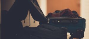 Suitcase with clothes on table at sober living home in Boston, Massachusetts