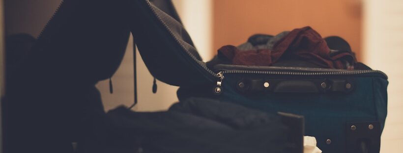 Suitcase with clothes on table at sober living home in Boston, Massachusetts